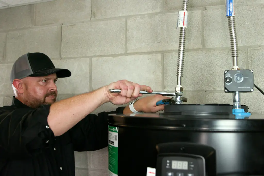 Professional contractor installing heat pump water heater